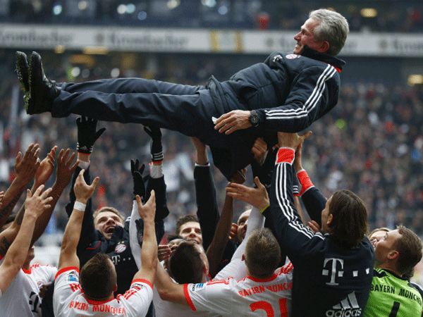 Bayern Munich players celebrate winning Bundesliga title by throwing coach Jupp Heynckes into the air.