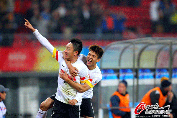 Qu Bo is congratulated by teammate after scoring the winner for Guizhou Renhe.
