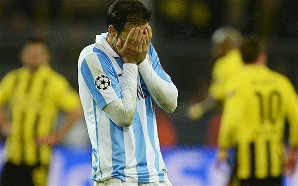 Heartbreak: Malaga beaten by last-gasp Borussia Dortmund winner.