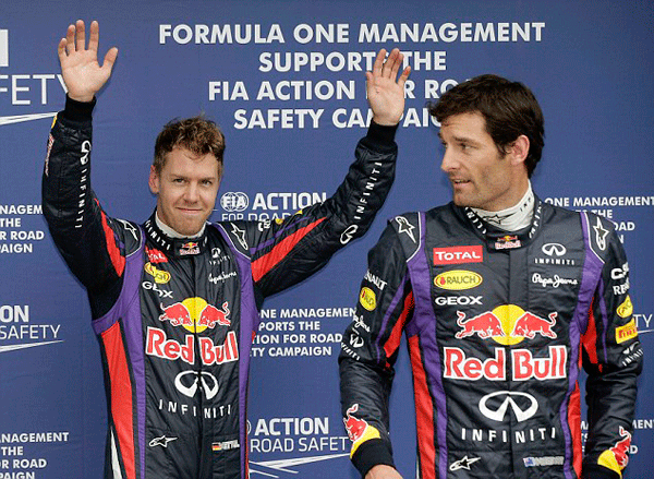 Vettel celebrates his win in Malaysia as Webber looks on.