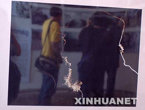 一张参展照片映照出参观者的身影（9月20日摄）。新华社记者燕雁摄