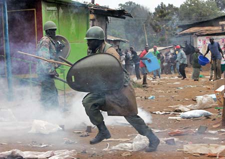 12月31日，内罗毕，一名防暴警察躲避示威人群投掷的石块。 