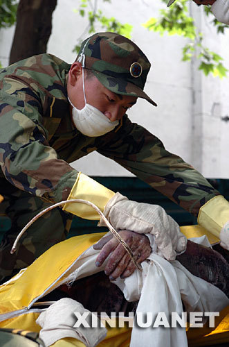 5月15日，解放军战士在绵竹市汉旺镇整理遇难者遗体
