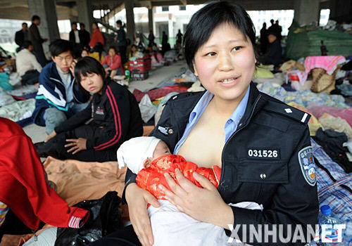5月16日，四川江油县公安局女民警蒋小娟在地震灾民庇护所为一名地震灾区孤儿喂奶