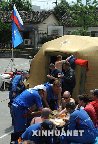 5月18日，俄罗斯救援队队员在自己的大本营吃中午饭。 5月16日，俄罗斯救援队抵达汶川大地震灾区，在3天的搜救过程中，成功救出了一名被困127小时的幸存者。