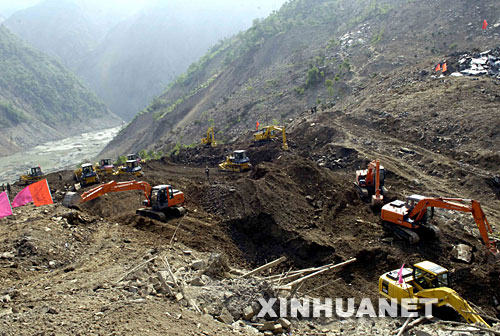 5月27日，多辆大型工程车在北川唐家山堰塞湖抢险现场作业。