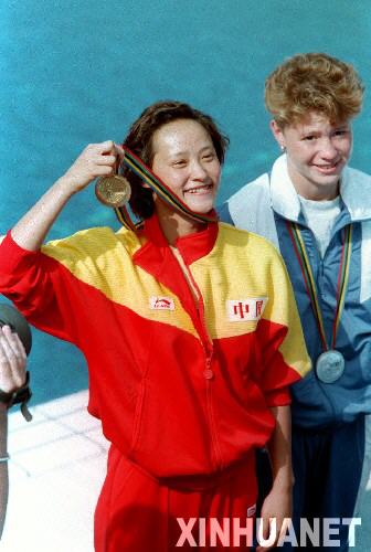圖為高敏（左）手拿金牌向觀眾致意。1992年8月3日，高敏獲第25屆巴塞羅那奧運會女子3米跳板跳水金牌。