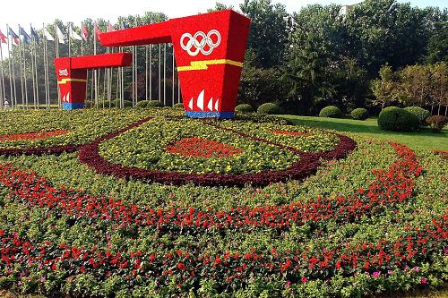 “奥运凯旋门”被一个由各色花卉和植物组成的大型花坛“包围”