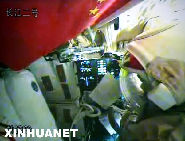 9月26日23时34分54秒，航天员翟志刚、刘伯明在神舟七号飞船轨道舱内试穿舱外航天服，进行适应性训练