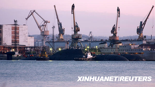 11月9日，在俄罗斯远东的大卡缅，两艘拖船帮助一艘核动力潜艇在码头停泊。
