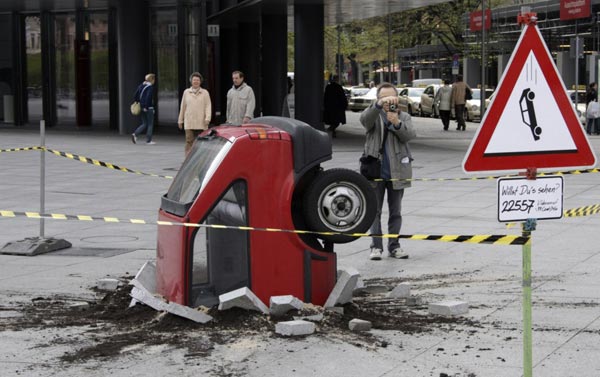 2008年4月14日，柏林波茨坦广场上陈列着一件未经证实的艺术作品——一辆撞进地面的汽车。 路透社/摄影 托比亚斯•施瓦茨（德国）