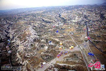 格在土耳其格雷梅，载满旅客的热气球纷纷起飞。在这里，乘坐热气球是一项非常重要的旅游项目。中国网图片库 栩同/摄