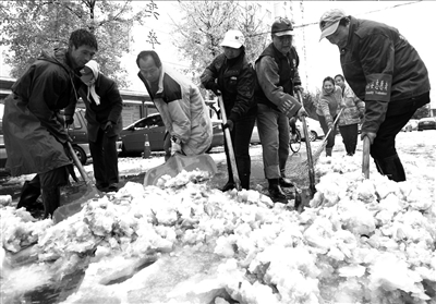 志愿者们在路上扫雪铲冰。本报记者范继文摄