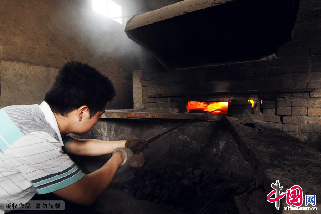 焙烧、锻打，初步成型，烧制铜砣的工序。中国网图片库 王海滨/摄