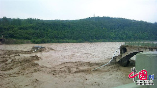 7月9日，四川綿陽江油市被特大洪峰衝擊垮塌的老青蓮大橋旁。（中國網圖片庫 高銳 手機拍攝圖片）