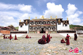 喇嘛在米拉日巴佛阁的大经堂外辩经。辩经指按照因明学体系的逻辑推理方式，辩论佛教教义的学习课程，是藏传佛教喇嘛攻读显宗经典的必经方式，多在寺院内空旷之地、树阴下进行。     中国网图片库  赖鑫琳/摄