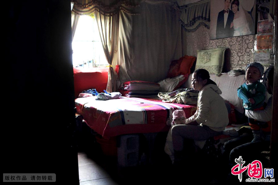 温馨的卧室让所有生活的艰难都烟消云散，窗帘、衣柜、结婚照。中国网图片库 李瑞昌/摄