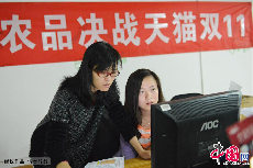 2013年11月11日，浙江省杭州市，某电商品牌的员工在电脑前查看网络销售的金额。中国网图片库 龙巍摄