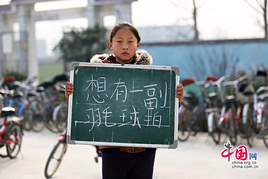 2013年1月14日，安徽省蚌埠市固鎮(zhèn)縣清涼小學(xué)，六年級(jí)學(xué)生在寒假即將來臨前，展示寒冬里的假期心愿。圖為張珂雲(yún)，寒假愿望是想有一副羽毛球拍。