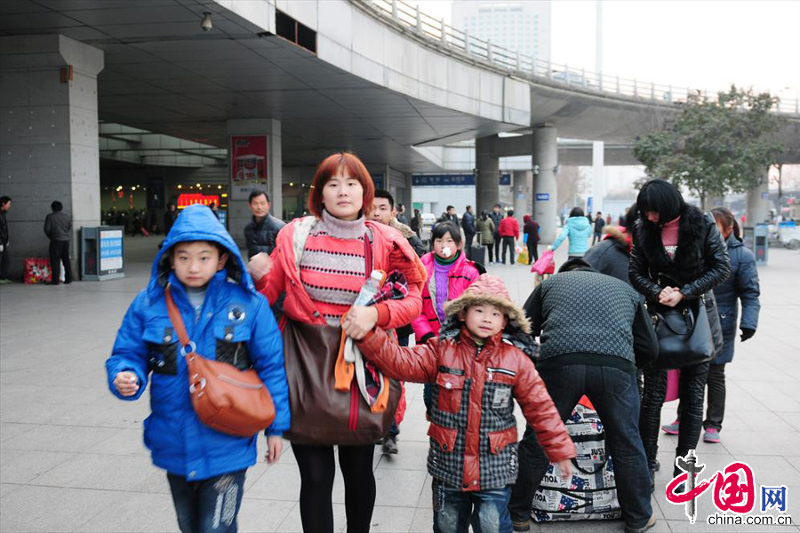 2014年1月16日，南京火车站，一位在宁打工的老乡拖家带口赶春运。当天，是2014年全国春运第一天。 中国网图片库 杨素平摄影