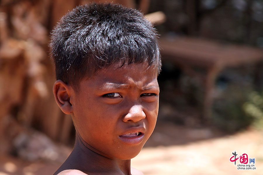 行走在高棉农村路上的黑瘦小男孩