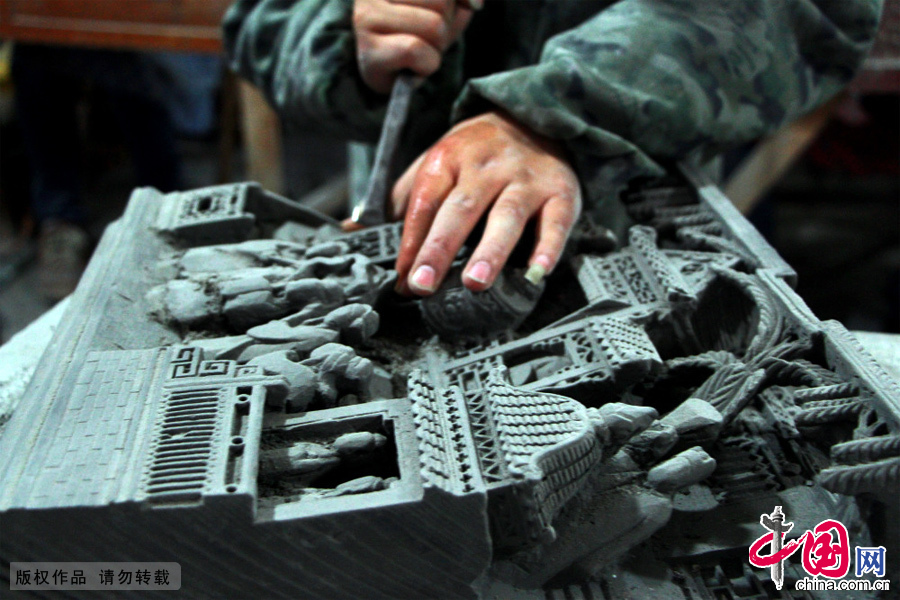 安徽省黄山市民间工匠运用传统的手工技艺在青灰砖上精雕细琢。