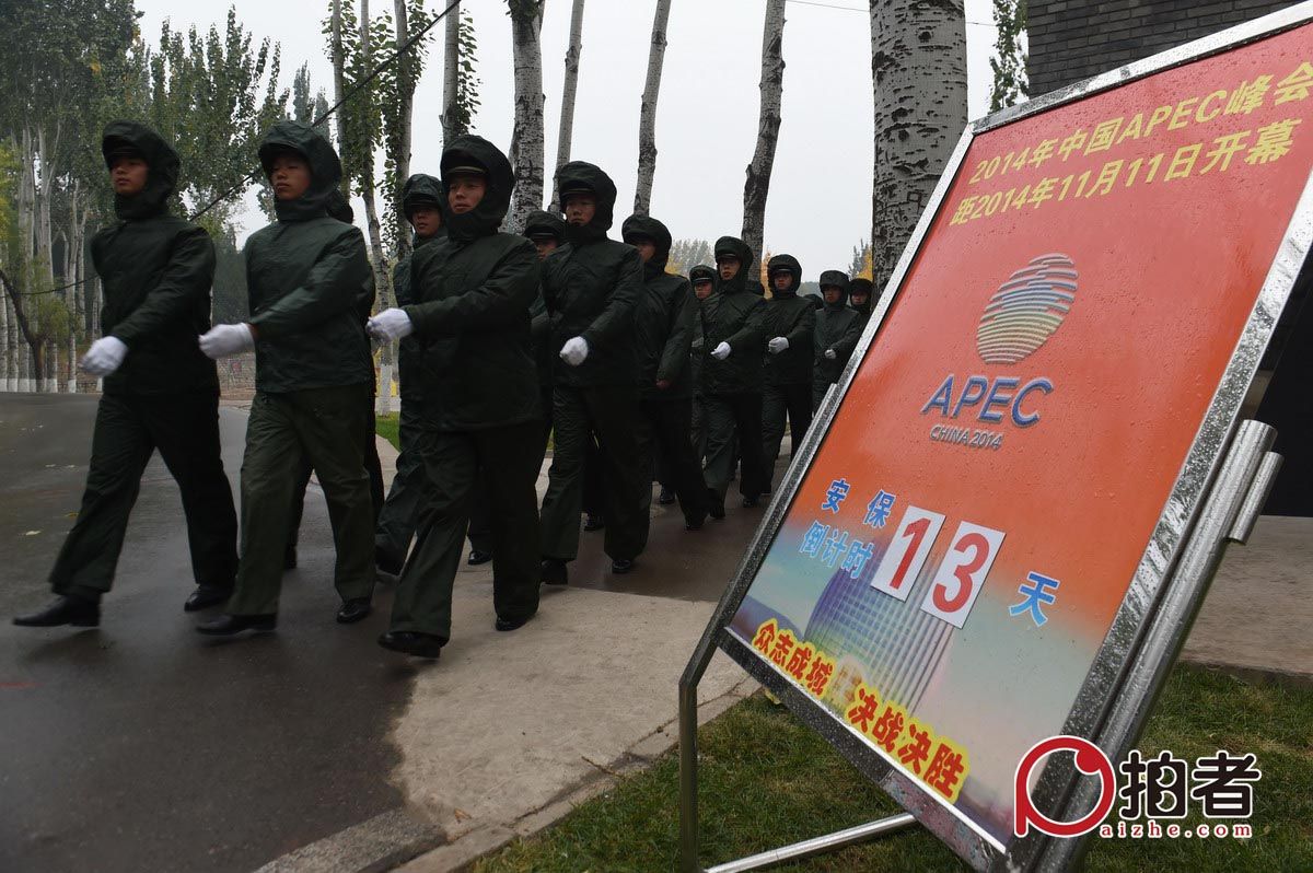 10月30日，执勤的武警官兵穿着雨衣走出营地前往APEC核心区站岗执勤。新京报记者 吴江 通讯员 王双战 摄