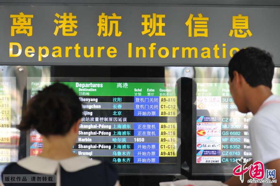 2014年10月11日，海南三亞鳳凰機場，旅客正在查看航班情況。
