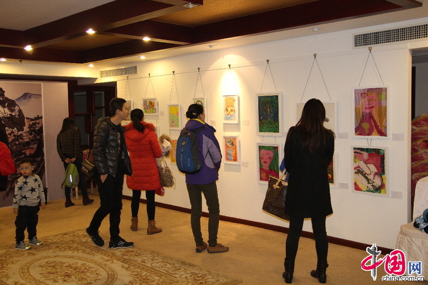 2014天羽同画少儿艺术中心学生作品展《同画.童话》，家长和孩子们在认真观看画展