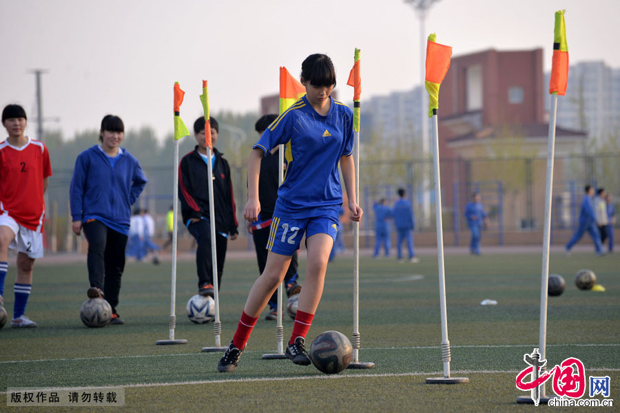 4月14日，河北省邯郸市一中女子足球队的球员们在进行带球训练。中国网图片库 郝群英摄 