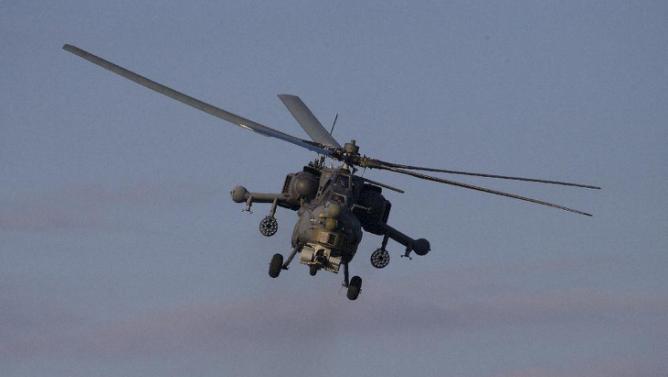 Russian MI-28 attack helicopter flies during the Army-2015 show at a shooting range in Alabino, outside of Moscow, Russia, on Tuesday, June 16, 2015. Russia’s military this year alone will receive over 40 new intercontinental ballistic missiles capable of piercing any missile defences, President Vladimir Putin said Tuesday in a blunt reminder of the nation’s nuclear might amid tensions with the West over Ukraine. (AP Photo/Ivan Sekretarev)