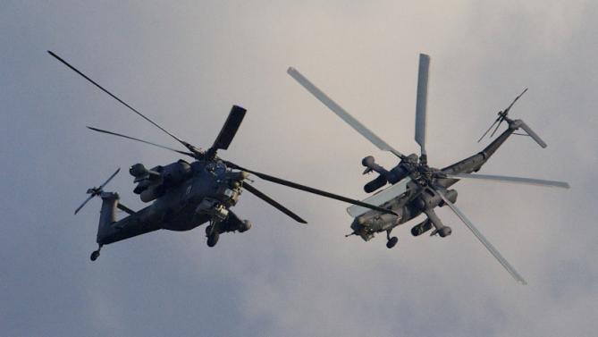 Russian MI-28 attack helicopters fly during the Army-2015 show at a shooting range in Alabino, outside of Moscow, Russia, on Tuesday, June 16, 2015. Russia’s military this year alone will receive over 40 new intercontinental ballistic missiles capable of piercing any missile defences, President Vladimir Putin said Tuesday in a blunt reminder of the nation’s nuclear might amid tensions with the West over Ukraine. (AP Photo/Ivan Sekretarev)