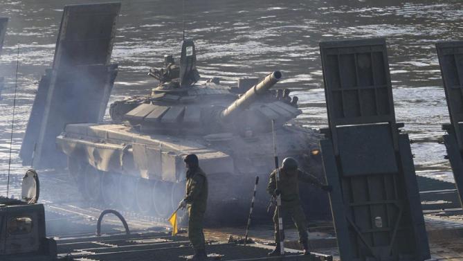 A Russian tank is taken across the river during the Army-2015 show at a shooting range in Alabino, outside of Moscow, Russia, on Tuesday, June 16, 2015. Russia’s military this year alone will receive over 40 new intercontinental ballistic missiles capable of piercing any missile defences, President Vladimir Putin said Tuesday in a blunt reminder of the nation’s nuclear might amid tensions with the West over Ukraine. (AP Photo/Ivan Sekretarev)