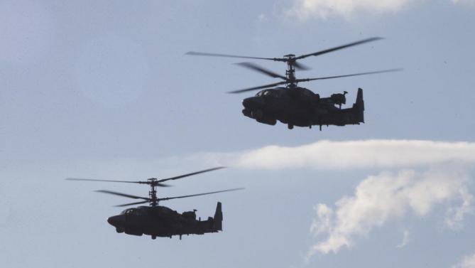 Russian Army's KA-52 helicopters fly during the Army-2015 show at a shooting range in Alabino, outside of Moscow, Russia, on Tuesday, June 16, 2015. Russia’s military this year alone will receive over 40 new intercontinental ballistic missiles capable of piercing any missile defences, President Vladimir Putin said Tuesday in a blunt reminder of the nation’s nuclear might amid tensions with the West over Ukraine. (AP Photo/Ivan Sekretarev)