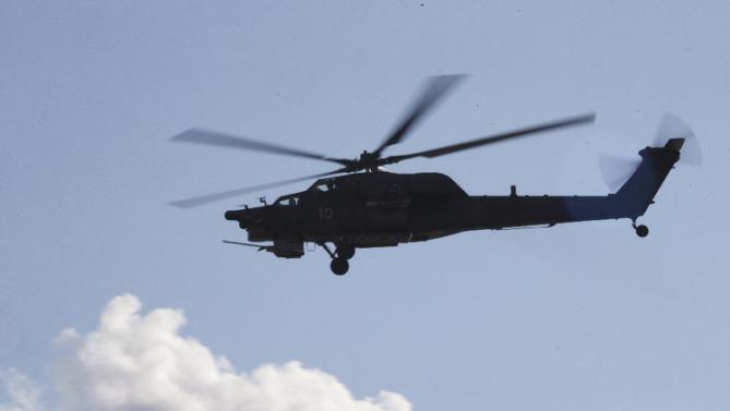 Russian Army's MI-28 helicopter flies during the Army-2015 show at a shooting range in Alabino, outside of Moscow, Russia, on Tuesday, June 16, 2015. Russia’s military this year alone will receive over 40 new intercontinental ballistic missiles capable of piercing any missile defences, President Vladimir Putin said Tuesday in a blunt reminder of the nation’s nuclear might amid tensions with the West over Ukraine. (AP Photo/Ivan Sekretarev)