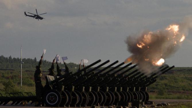 Russian Army's MI-28 attack helicopter flies as salute cannons fire during a show at a shooting range in Alabino, outside of Moscow, Russia, on Tuesday, June 16, 2015. Russia’s military this year alone will receive over 40 new intercontinental ballistic missiles capable of piercing any missile defences, President Vladimir Putin said Tuesday in a blunt reminder of the nation’s nuclear might amid tensions with the West over Ukraine. (AP Photo/Ivan Sekretarev)