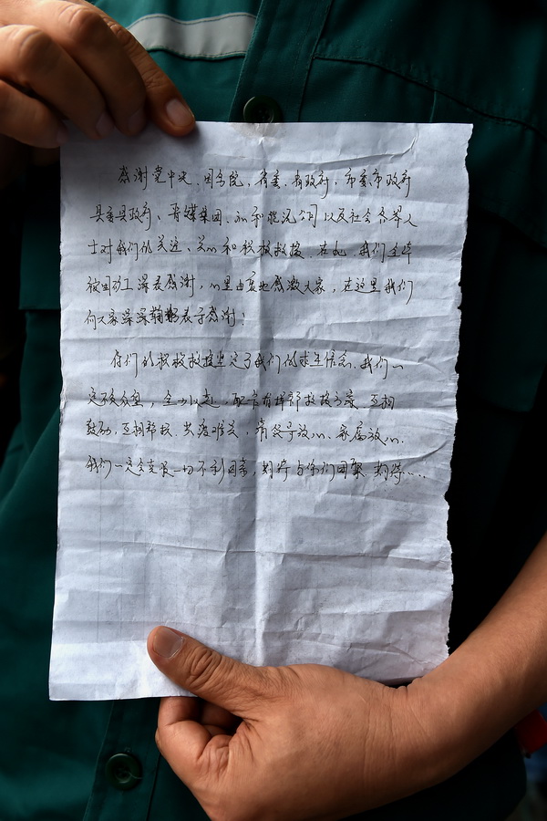 7月5日，救援人员展示被困矿工向地面发来的信。 新华社记者 詹彦 摄