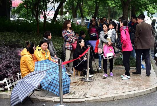 在合肥经开区一所私立幼儿园门口，报名的家长们已排队等候20多个小时（2016年5月10日摄）。 新华社记者刘军喜摄