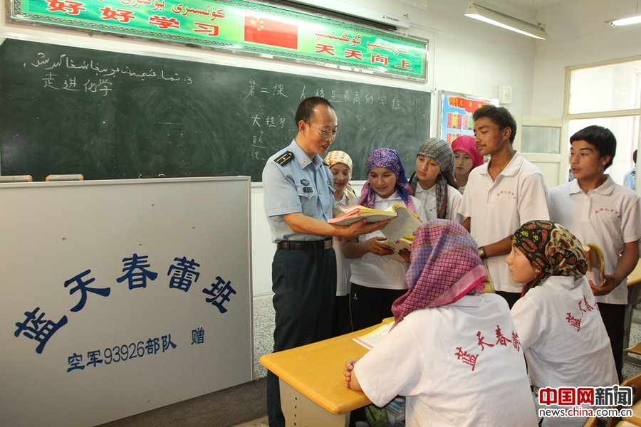 驻和田空军某指挥所干部范小勇,利用业余时间为蓝天春蕾学生辅导功课.