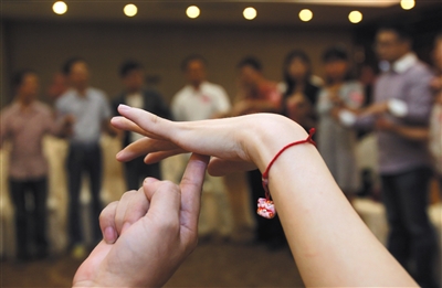 一家大型婚恋网站举办的交友派对上,单身男女青年在做游戏。 图/视觉中国