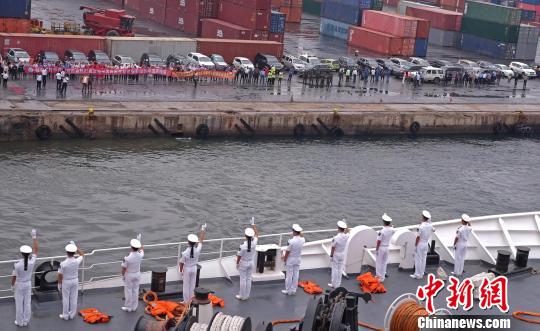 中国海军和平方舟医院船缓缓驶离安哥拉罗安达港时，海军官兵与前来送行的人群挥手告别。　江山 摄