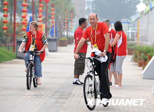 Le 28 juillet, des membres des délégations étrangères visitent le Village olympique en vélo.