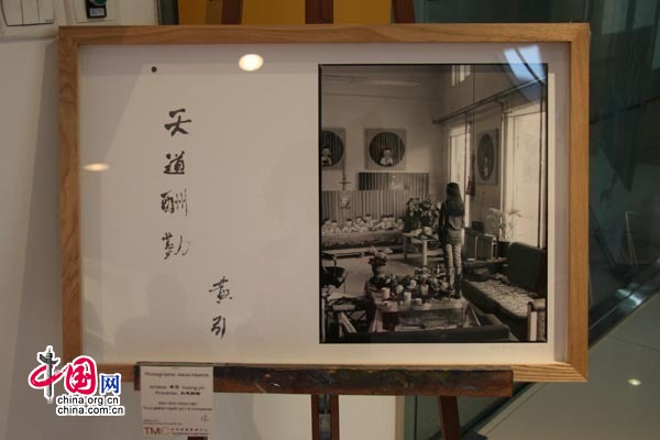 L'artiste chinois Yi Xuan pose avec son portrait.