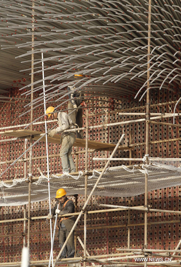 Des travailleurs démolissent les tubes en acrylique du pavillon du Royaume-Uni dans le parc de l&apos;Exposition universelle de Shanghai, le 8 décembre 2010. La démolition de quelque 60 000 tubes en acrylique sera terminée à la fin de l&apos;année.