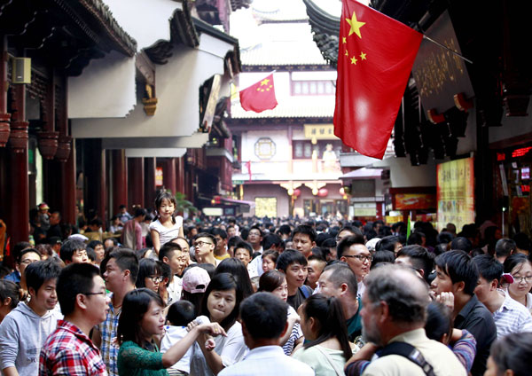 Les touristes affluent dans la rue commerçante du jardin Yuyuan à Shanghai, le 1er octobre 2014, à l'occasion de la semaine de vacances de la fête nationale. [Photo de Ding Ting / China Daily]