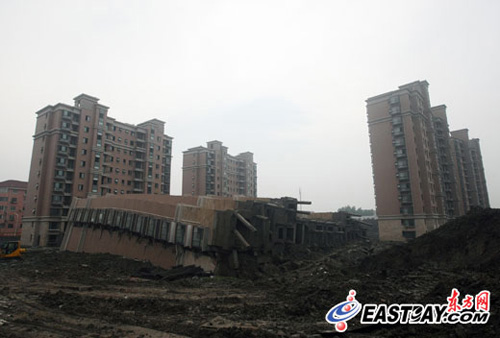 Ein 13-st?ckiges im Bau befindliches Geb?ude ist am Samstag in Shanghai umgestürzt und hat einen Bauarbeiter unter sich begraben. Der Mann wurde tot geborgen.