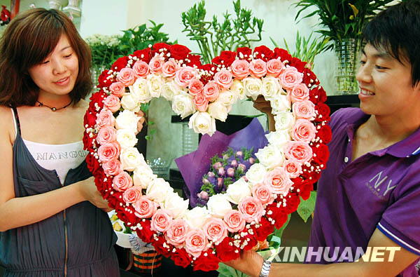 Mitarbeiter eines Blumenladens in Suzhou zeigt einen herzförmigen Rosenstrauß. (25. August 2009)