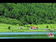 Am Ufer des Sees befindet sich ein kleines Haus.