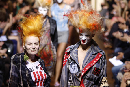 British fashion designer Vivienne Westwood (L) arrives with at model at the end of her Spring/Summer 2010 collection during Paris Fashion Week October 2, 2009.