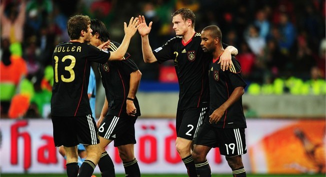 Marcell Jansen of Germany celebrates scoring his side's second goal with team mates Thomas Mueller and Cacau
